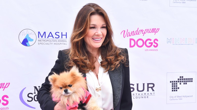Lisa Vanderpump holding a dog and posing