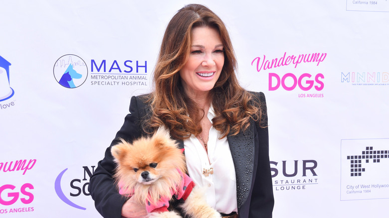 Lisa Vanderpump holding a dog and posing