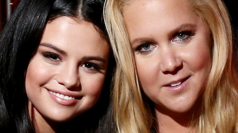 Amy Schumer and Selena Gomez hugging 