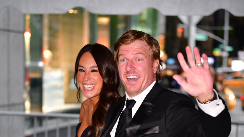 Joanna and Chip Gaines smiling, waving