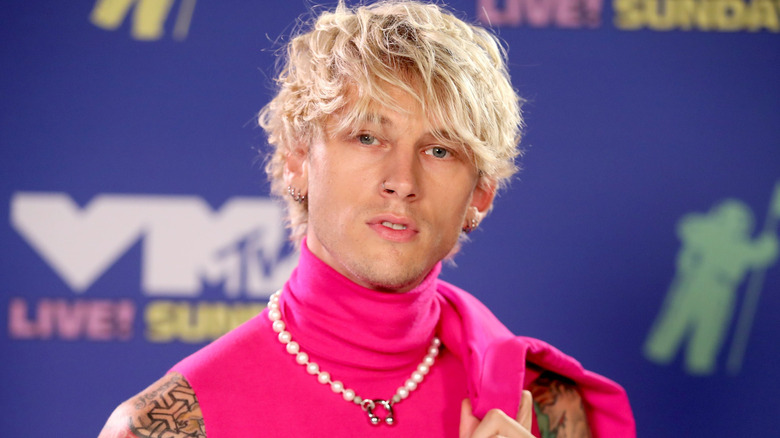 Machine Gun Kelly wearing pink turtleneck