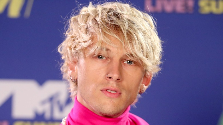 Machine Gun Kelly wearing pink turtleneck
