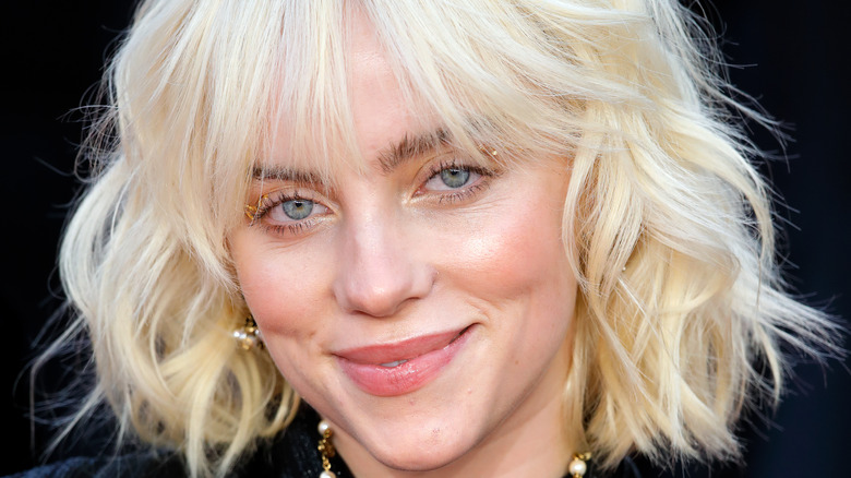 Billie Eilish smiling with blonde hair