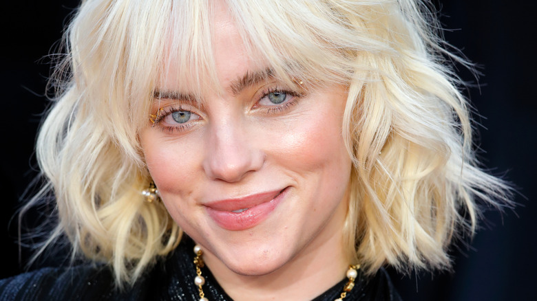 Billie Eilish smiling with blonde hair