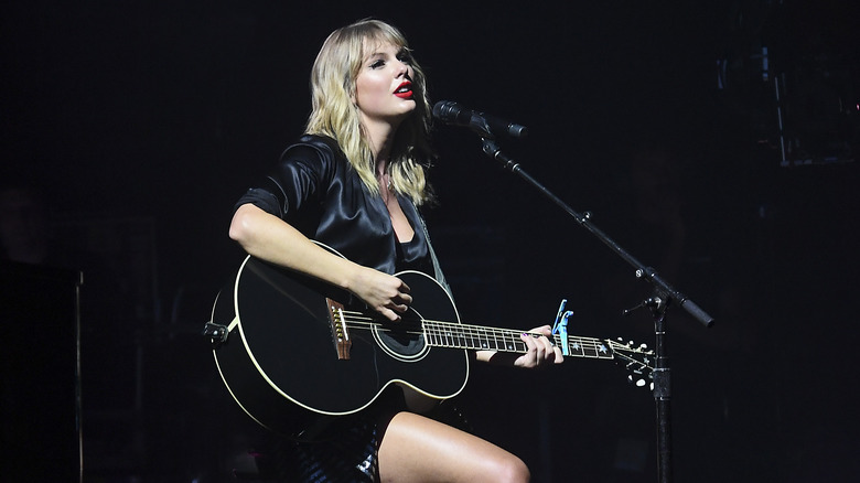 Taylor Swift singing and playing guitar