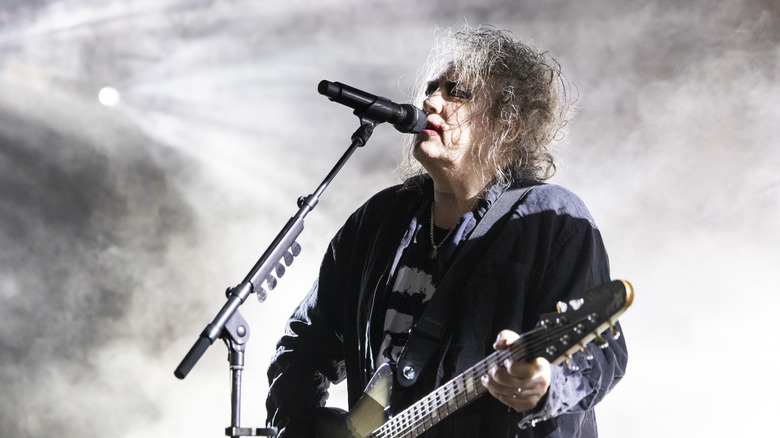 Robert Smith singing and playing guitar