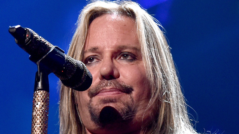 Vince Neil in front of a microphone