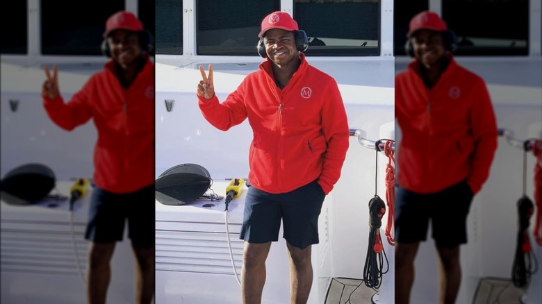 Mzi "Zee" Dempers flashing peace sign on deck 