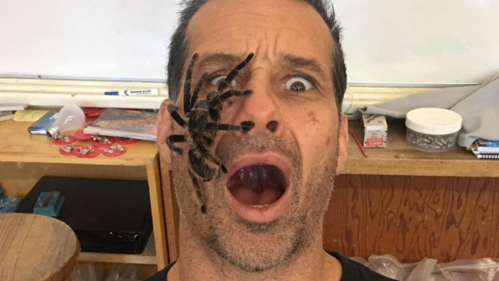 Gary Golding of Naked and Afraid XL with at huge spider on his face 