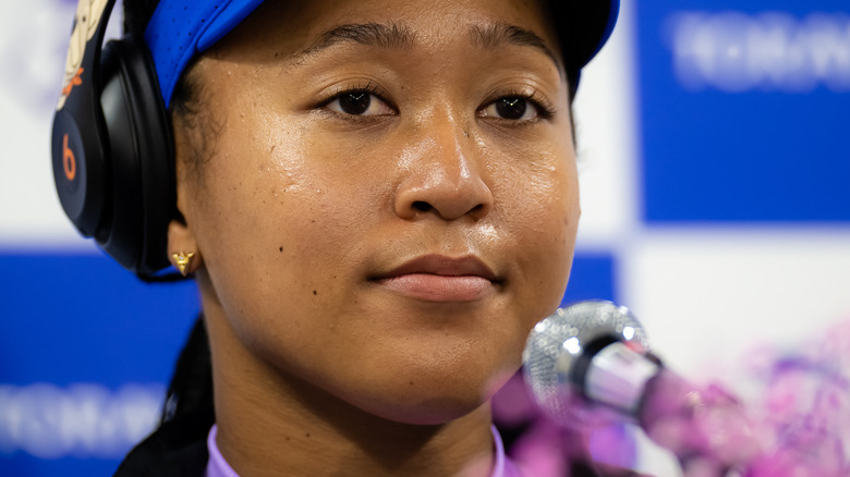 Naomi Osaka resting her face on her hands