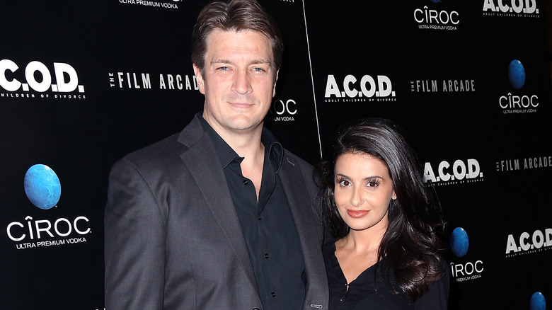 Nathan Fillion and Mikaela Hoover posing