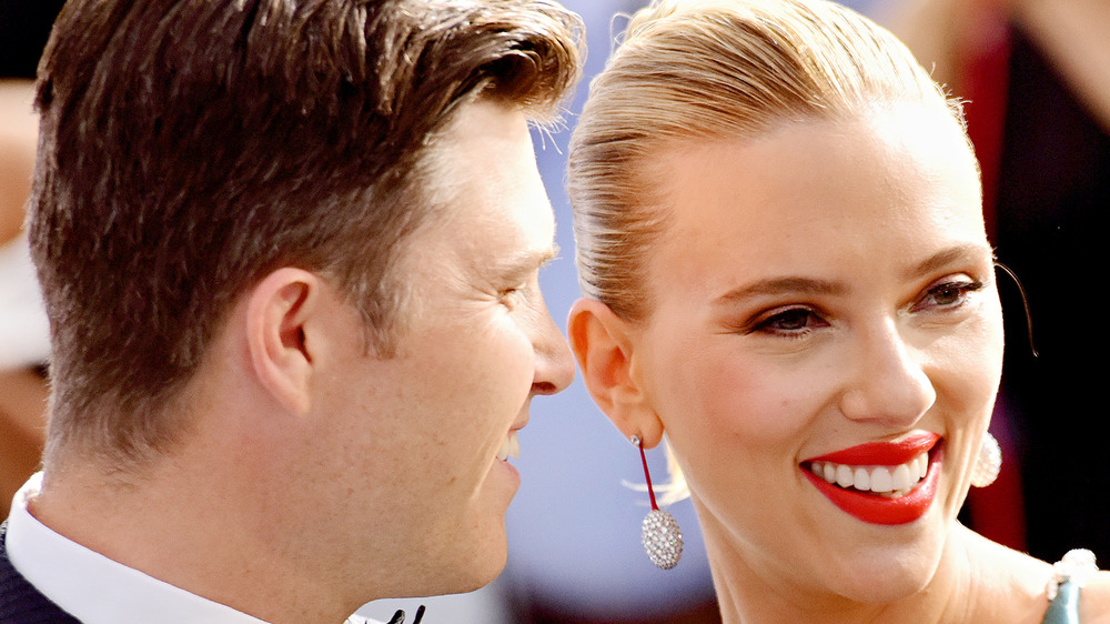 Colin Jost and Scarlett Johansson posing together