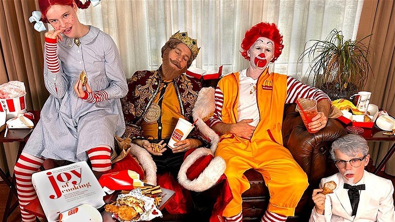 Neil Patrick Harris and family surrounded by fast food in costume as mascots