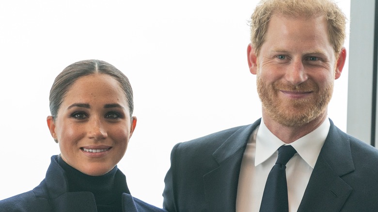 Meghan Markle Prince Harry black suits smiling