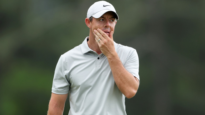 Rory McIlroy playing golf wedding ring