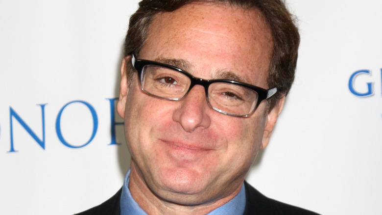 Bob Saget smiles on the red carpet