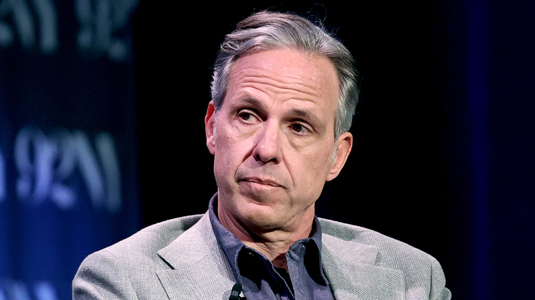 Jake Tapper sits at a 2025 event