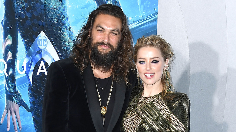 Jason Momoa and Amber Heard posing