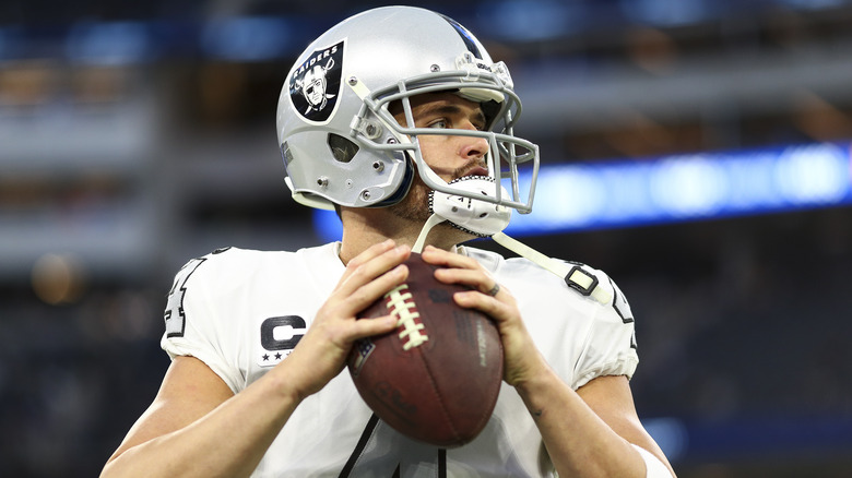 Derek Carr in Raider uniform with football