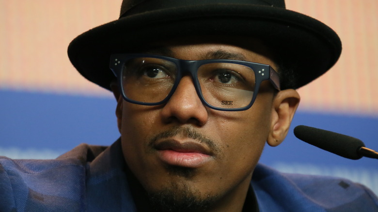 Nick Cannon in glasses and hat