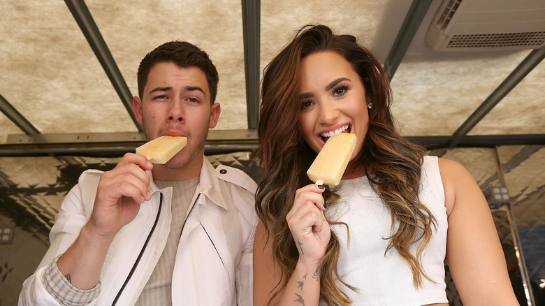 Nick Jonas and Demi Lovato eating ice cream.