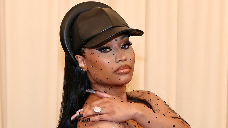 Nicki Minaj looking at camera in black cap 2022 Met Gala