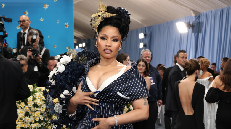 Nicki Minaj attends the Met Gala in a pinstriped dress