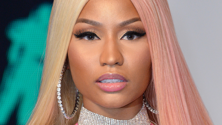 Nicki Minaj with blonde hair and serious expression