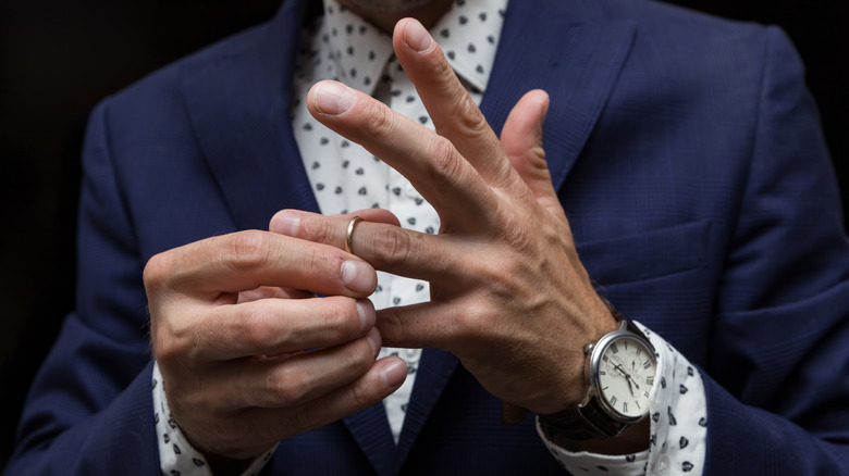 Man taking wedding ring off