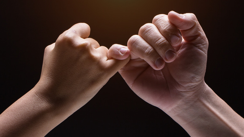 Hands locking pinkies