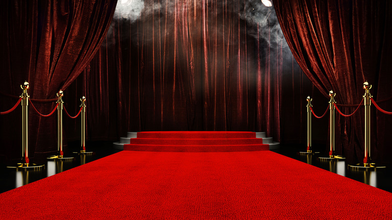 Red carpet leading to curtains 