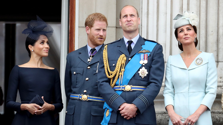 Meghan Markle smiling in cream coat