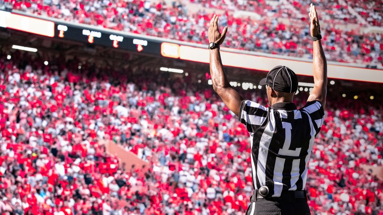 Football ref signaling a touchdown