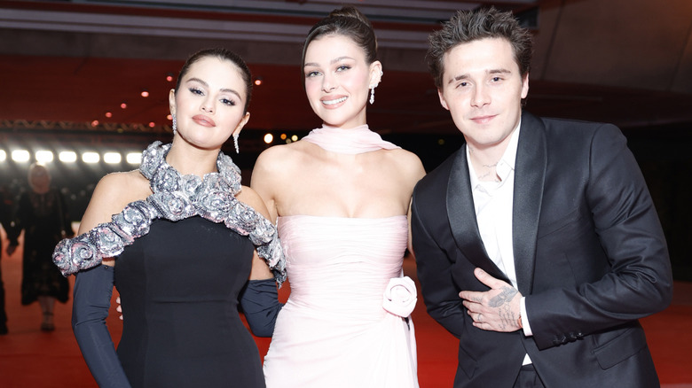 Selena Gomez, Nicola Peltz, and Brooklyn Beckham pose in 2023