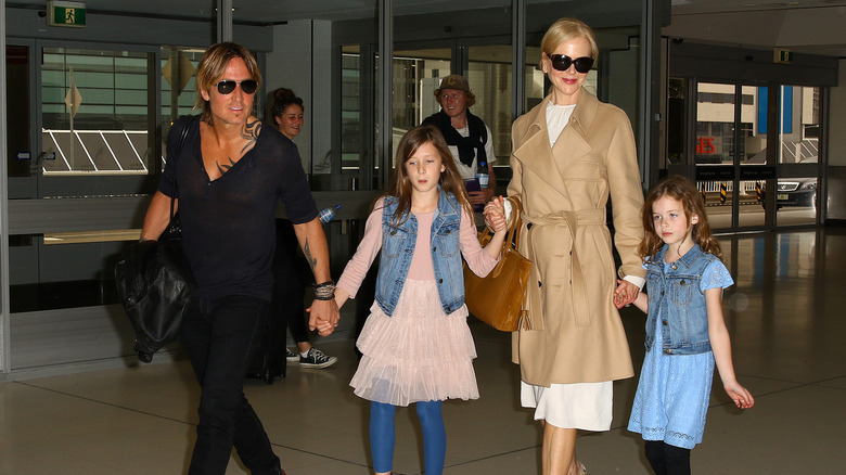 Nicole Kidman and Keith Urban walk with their young daughters.