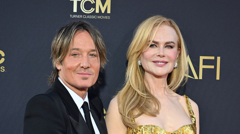 Keith Urban and Nicole Kidman smiling while posing at an event together