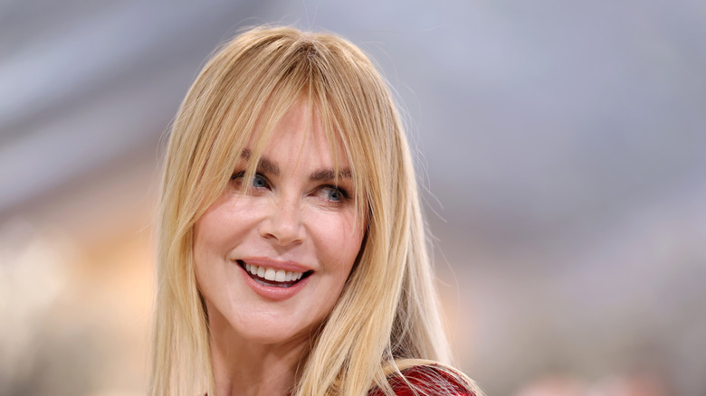 Nicole Kidman smiling while looking over her shoulder