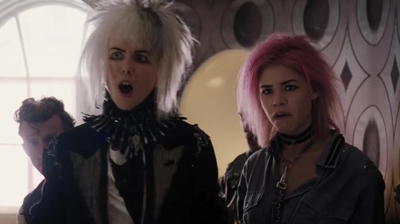 Nicole Kidman with her mouth wide open and dressed in punk clothes with a choppy, white and black wig on
