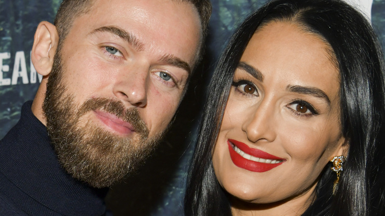 Artem Chigvintsev and Nikki Bella posing