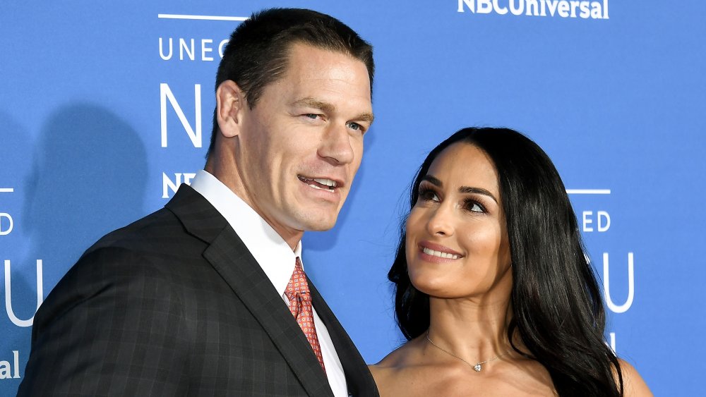 Nikki Bella looking up at John Cena on the red carpet 