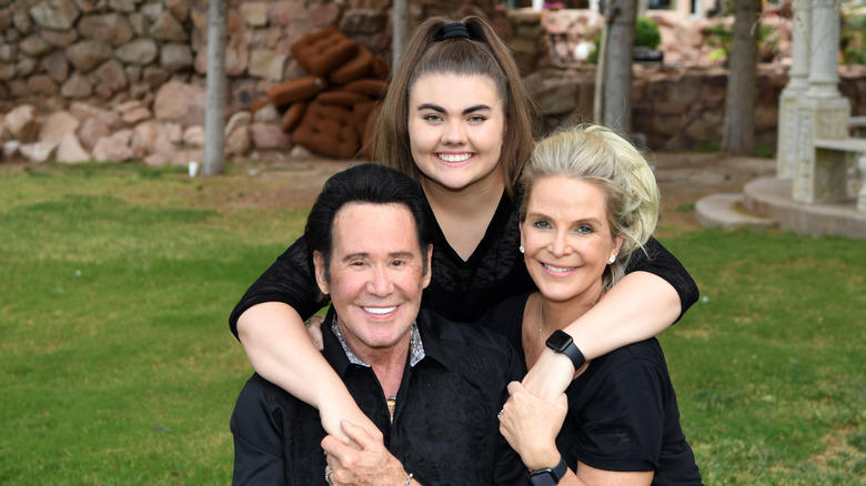 Wayne Newton, Lauren Newton, and Kathleen McCrone sitting outside
