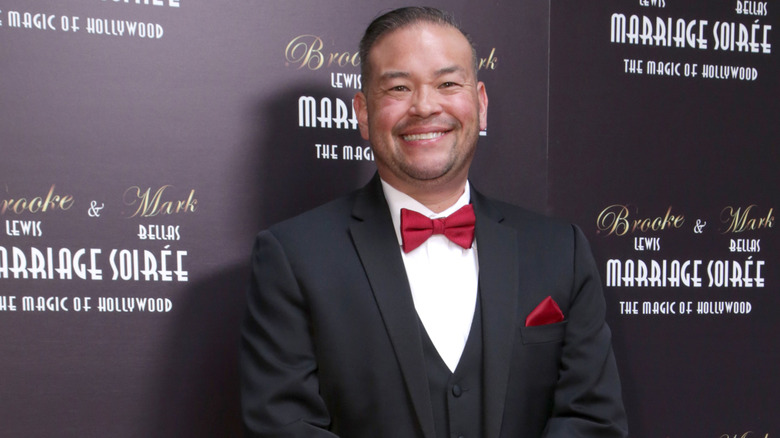 Jon Gosselin smiling while posing at an event in a tuxedo with a red bowtie
