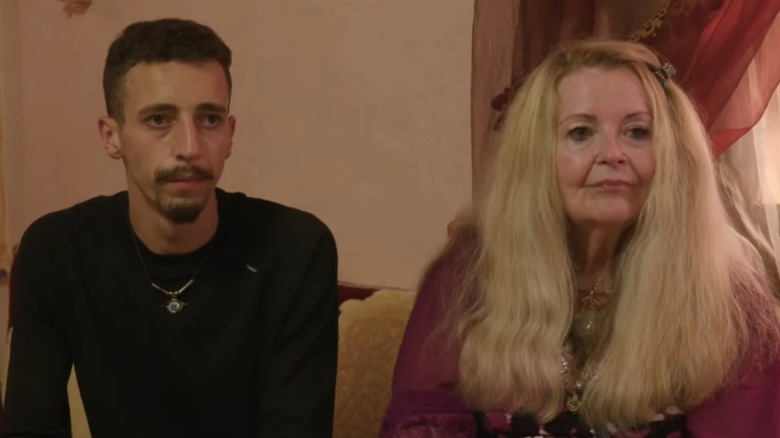 Still of Oussama Berber and Debbie Aguero seated on a couch on 