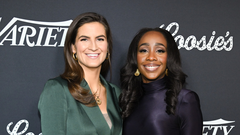 Kaitlan Collins and Abby Phillip smiling while posing together