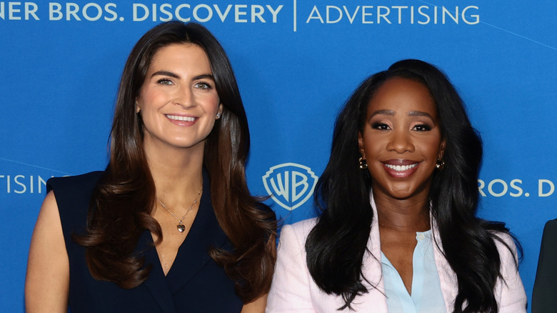 Kaitlan Collins and Abby Phillip smiling while posing together