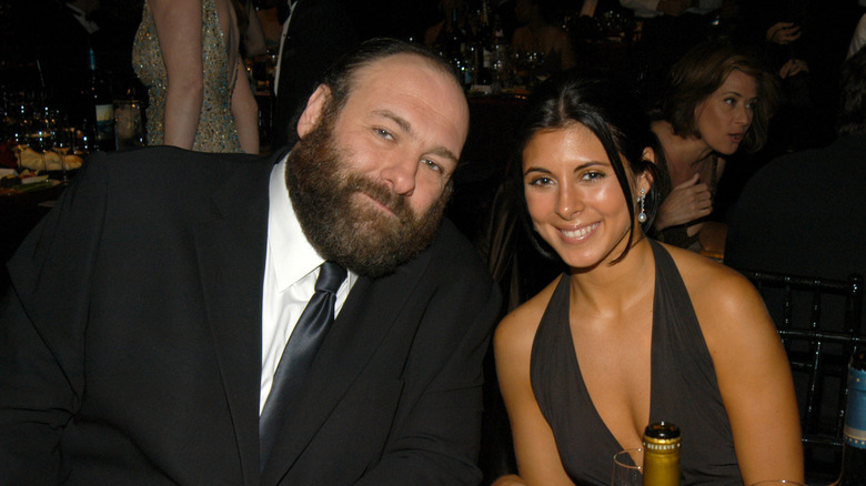 Jamie-Lynn Sigler and James Gandolfini sit together at a table.