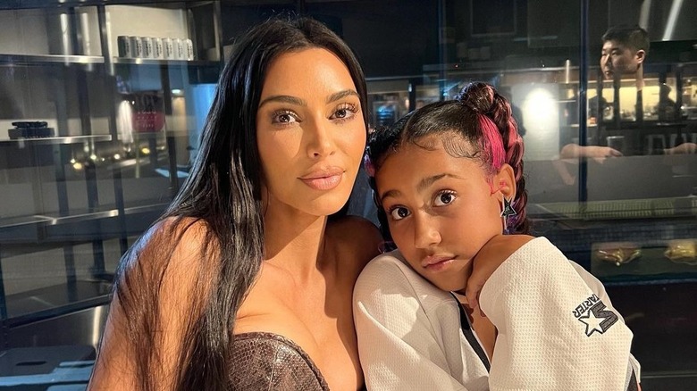 Kim Kardashian posing with North West