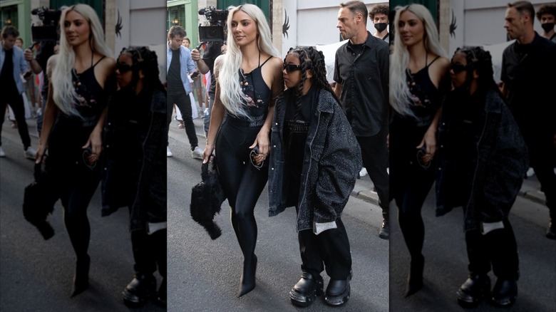 Kim Kardashian and North West are walking on the street during Paris Fashion Week
