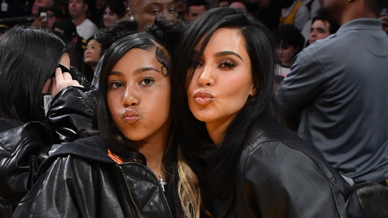 Kim Kardashian (R) and North West attend a basketball game between the Los Angeles Lakers and the Golden State Warriors at Crypto.com Arena