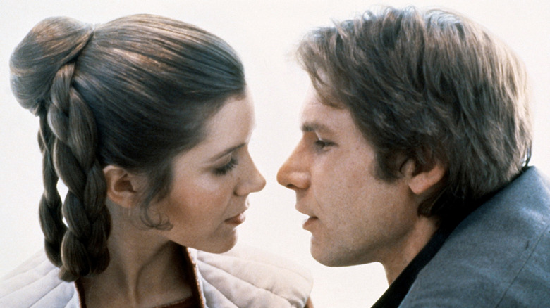 Still shot of Carrie Fisher and Harrison Ford gazing at each other while filming a scene in The Empire Strikes Back.